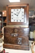A large early to mid 20th-century Blick Time Recorder Limited mechanical time clock, having a wooden
