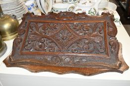 A 19th-century carved oak wall mounted letter holder, of floral and foliate decoration,