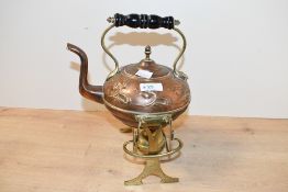An early 20th-century Beldray Art Nouveau-style copper and brass tilting spirit kettle and stand,