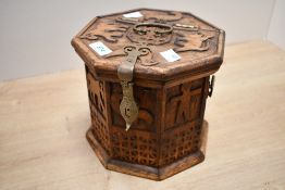 A vintage Middle Eastern-style octagonal wooden box, featuring hand carved animal and figural motifs