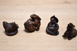 Four 20th-century boxwood Japanese Netsuke animal figures, to feature a chicken pair, a bunny with a