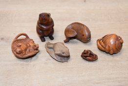 A selection of 20th-century boxwood and resin Japanese Netsuke animal figures, to feature three frog