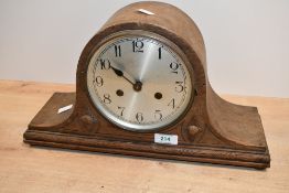 A 20th-century Art Deco-style wooden mantel clock, featuring a brushed metal dial of Arabic numerals