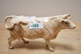 A 20th-century Beswick pottery Charolais Cow figurine, model 3075A, with a light brown glossy