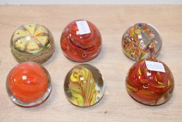 Six 20th-century art glass paperweights, to feature an Isle of White example and an Indian