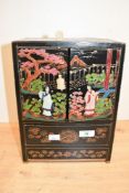 A small early to mid 20th-century Chinisorie black lacquer tabletop cabinet, to feature hand painted
