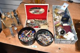A faux leather jewellery box, containing an assortment of costume jewellery, along with a wooden box