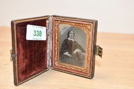 A 19th-century leather-cased portrait ambrotype of a female, with a decorative ornate gilt frame,