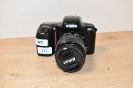 A Nikon F50 camera with Nikon Nikkor 35-80mm 1:4-5,6D lens