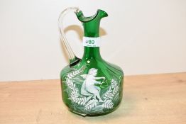 A 19th-century Mary Gregory-style green glass ewer, featuring white enamel decoration depicting a