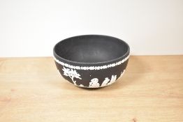 A Wedgwood black Jasper ware bowl, of traditional dished circular form sprigged with a classical
