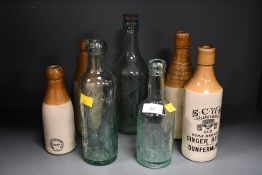 A selection of late 19th to early 20th-century glass and stoneware bottles, to feature a ceramic S.