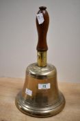 A large 20th-century brass hand held bell, having a turned wood handle, unmarked, 31cm, condition is