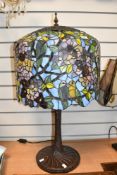 An impressive contemporary Tiffany-style table lamp, featuring a large birdcage-like finial and a