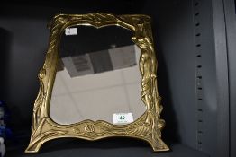 A 20th-century Art Nouveau-style patinated brass tabletop mirror, to feature a delicately rendered