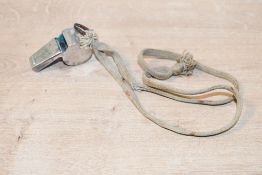 A vintage The Acme metal sports whistle, with rope attached, marked to whistle, 5cm, condition is