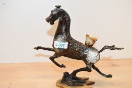 A 20th-century Chinese bronze Flying Horse of Gansu-style sculpture, featuring decorative inlaid