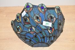 Two contemporary Tiffany-style wall sconce shades, featuring delicate Peacock decoration,