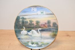 A 20th-century decorative Swan plate, featuring a pair of hand painted Swans against a pastoral lake