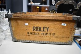 A large vintage Ridley Wholesale Chemists Limited wooden crate, featuring metal bound sides and twin