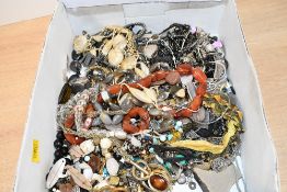 An assortment of costume jewellery, including agate bead necklaces, statement pieces, clip-on
