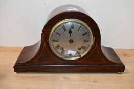 An Edwardian stary inlaid mahogany mantel clock of arched form, featuring a gilt face of Roman