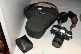 An Olympus OM10 camera with Miranda 35-70mm 1:3,5-4,5 MC Macro lens and flash in camera bag