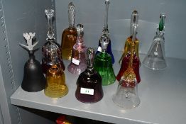 A fine selection of late 19th to 20th-century colourful glass hand bells, of varying colours and