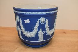 A large 20th-century Wedgwood blue jasperware jardinière, featuring sprigged neoclassical relief