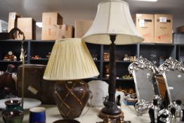 Two 20th-century Indian-style pottery table lamps, of differing forms featuring fibrous lattice