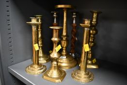 A selection of 20th-century brass candlesticks, to include two pairs; sold with two wooden barley