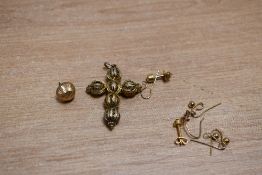 A yellow metal filigree cross pendant, along with a small assortment of odd earrings and earring