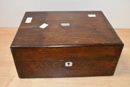 A Victorian rosewood box, having a hinged lid with an inlaid mother-of-pearl escutcheon, 21cm x
