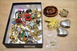 A collection of costume brooches, including paste set pieces, poppy brooches, statement pieces and