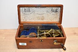 A Victorian mahogany-cased Magneto-Electric shock therapy machine, featuring a hand cranked