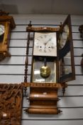 A late 19th-century Anglo-American drop dial-style wall clock, having a walnut inlaid case with