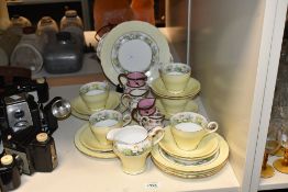 A selection of 20th-century Aynsley bone china part tea set, featuring a soft yellow palette of