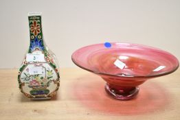 A 20th-century cranberry art glass pedestal bowl; sold with a small Oriental-style vase, featuring