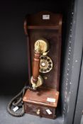 A vintage-style Steepletone 'Classic Museum Series' wooden wall telephone, with a brass-toned phone,
