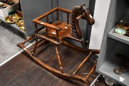 A fine Victorian mahogany rocking horse, featuring a sweetly hand carved head and neck and an
