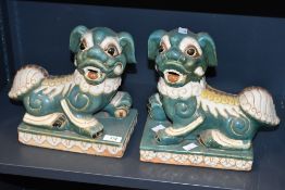 Two 20th-century Chinese glazed ceramic mantel Foo Dogs, of a sea foam green ground with cream and
