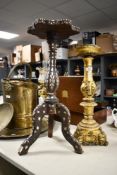 A late 19th to early 20th-century Indo Persian-style dark wood tripod table, featuring mother-of-