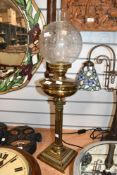 A Victorian Corinthian column-style brass oil lamp, featuring an acid-etched floral globe-formed