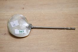 A Victorian mother-of-pearl caviar serving spoon, featuring a Gothic-style white metal handle,
