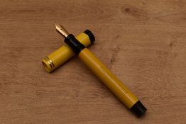 A Parker Duofold Senior Lucky Curve button fill fountain pen in Mandarin Yellow with two narrow