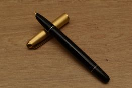 An Aurora 88 vacuum fill fountain pen in Black with gold fill cap. Circa 1944. Small ding to cap