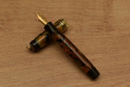 A Parker Duofold Streamlined Vest Pocket button fill fountain pen in Pearl and Black with three