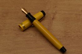 A Parker Duofold Streamline Senior button fill fountain pen in Mandarin Yellow with two narrow bands
