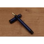 An Osmia Supra Normal button fill fountain pen in Lapis Lazuli Blue with two bands to the flat top