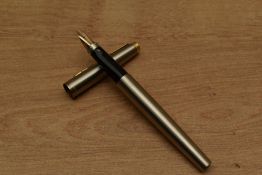 A Parker 75 Flighter Deluxe converter fill fountain pen with gold plated trim having Parker 14K